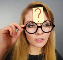 Woman having question mark on forehead thinking