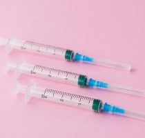 Three,Syringes,For,Injections,On,A,Pink,Background.,Vaccination,And