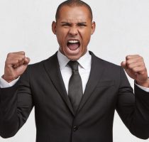 Aggressive,Mixed,Race,Young,Businessman,Has,Clenched,Fists,,Shouts,Loudly