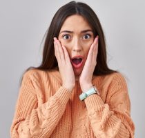 Young,Brunette,Woman,Standing,Over,White,Background,Afraid,And,Shocked,